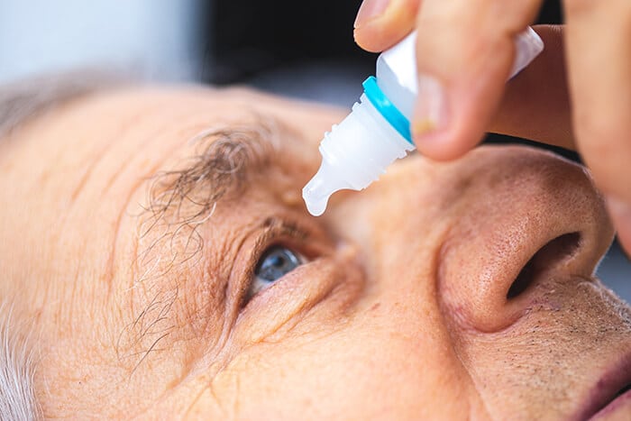 Person putting in eye drops